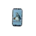 A small rectangular tin with a vintage illustration of a cat in a dress holding a basket, placed on a light wood surface.