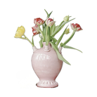 Pink ceramic vase with tulips on a white background