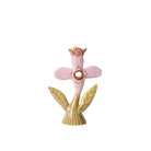 Decorative pink flower-shaped object with gold accents on a white background