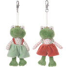 Two green plush frog keychains with red dresses on a white background