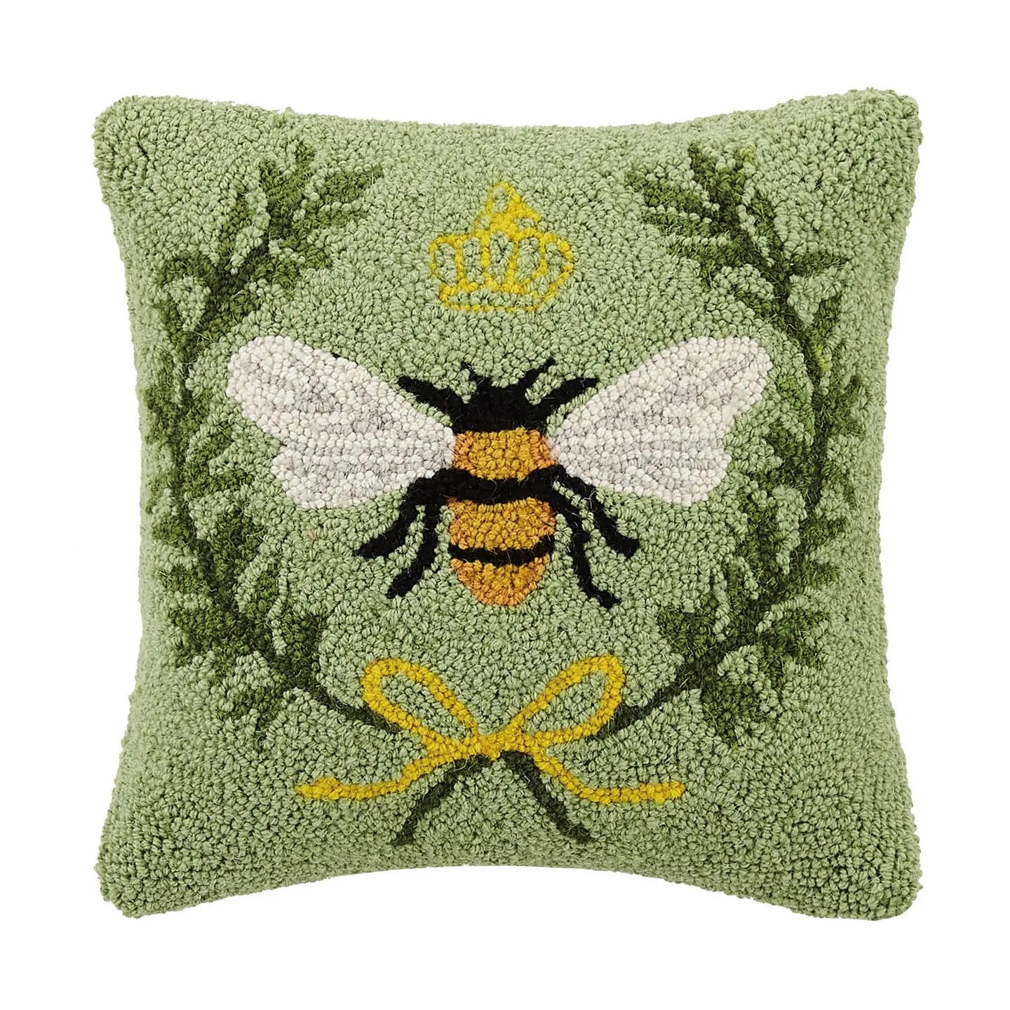Decorative pillow with a bee design on a green background