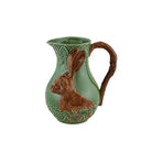 Ceramic pitcher with a rabbit design on a white background
