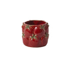 Red ceramic container with gold leaf designs on a white background