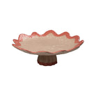 Decorative ceramic bowl with scalloped edge on a white background