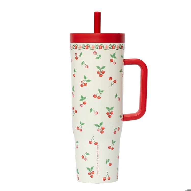 Tumbler with cherry pattern and red handle on a white background
