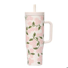 Floral-patterned tumbler with a handle on a white background