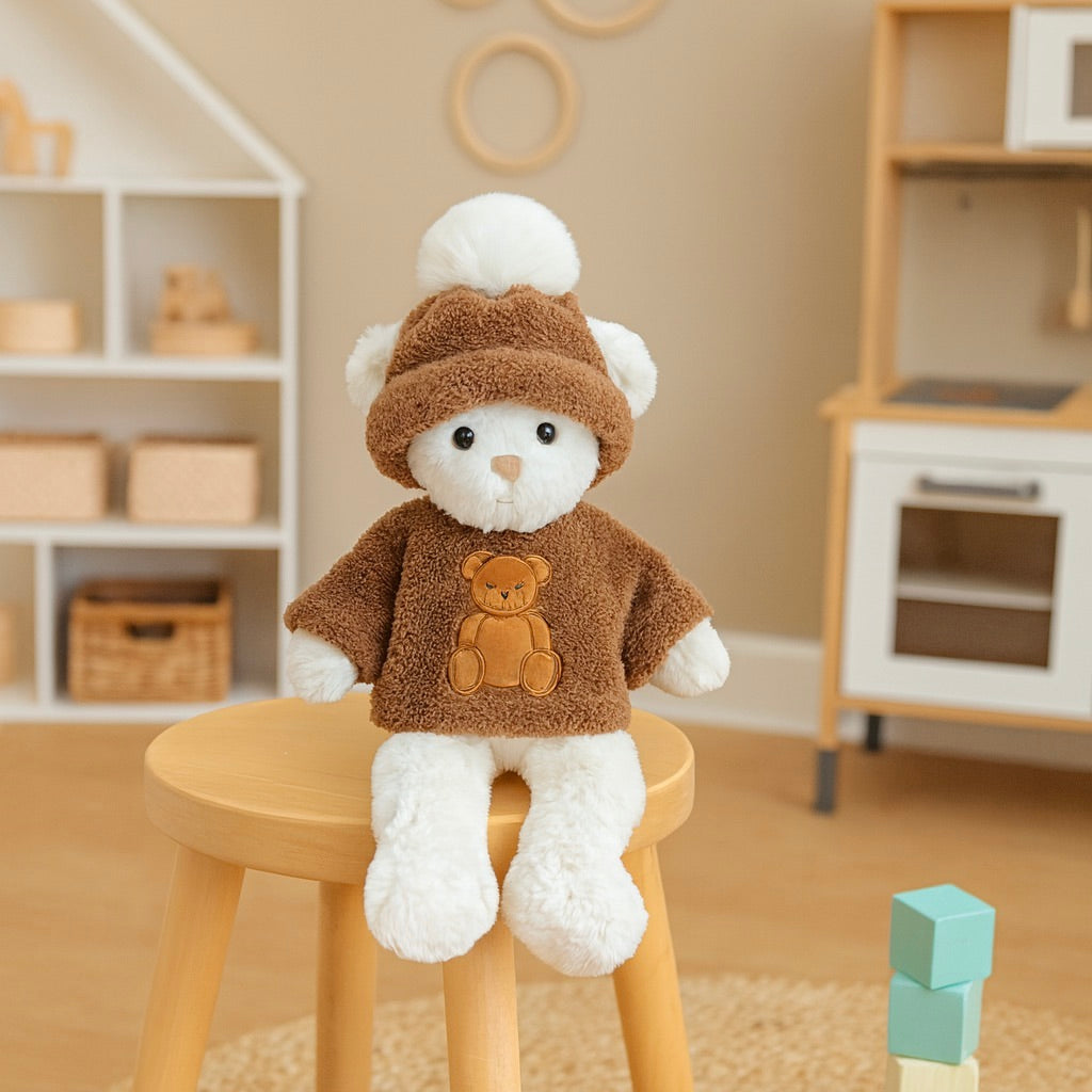 White teddy bear in a brown outfit sitting on a wooden stool in a child's playroom.