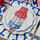 Decorative plate with a popsicle design and 'Happy Fourth' text on a table setting.
