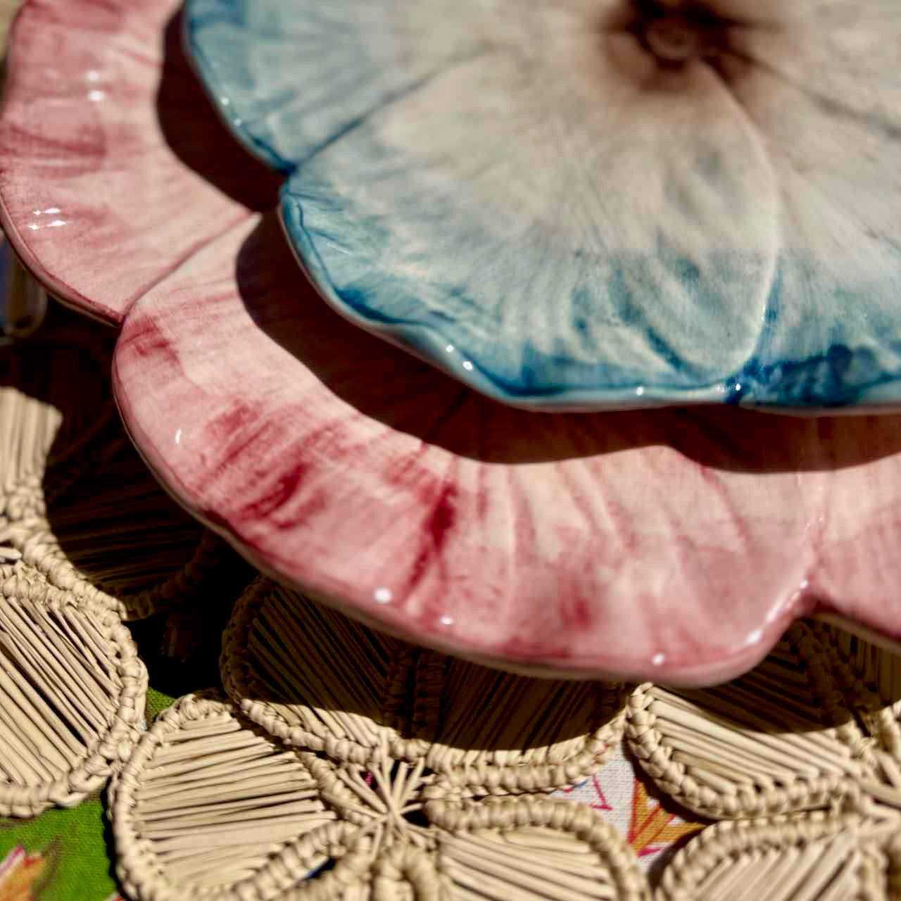 Set of ceramic plates with textured surfaces on a woven mat