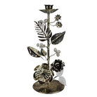 Decorative metal candle holder with floral designs on a white background