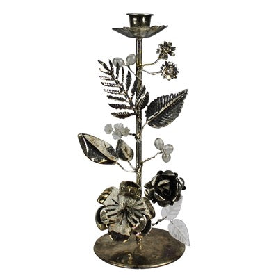 Decorative metal candle holder with floral designs on a white background