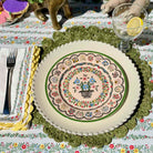 Decorative plate with floral design on a patterned tablecloth