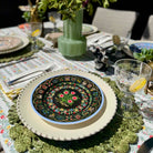 Decorative table setting with a floral plate and green placemat.