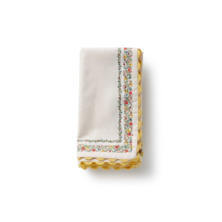 White napkin with floral border on a white background