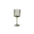 Smoky green glass candle holder on a white background