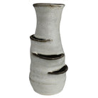 A handmade ceramic planter with a textured, speckled off-white glaze and dark brown unglazed terraced tiers, shown against a plain white background.