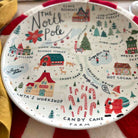 Decorative plate with Christmas-themed design featuring the North Pole and Santa's Workshop.