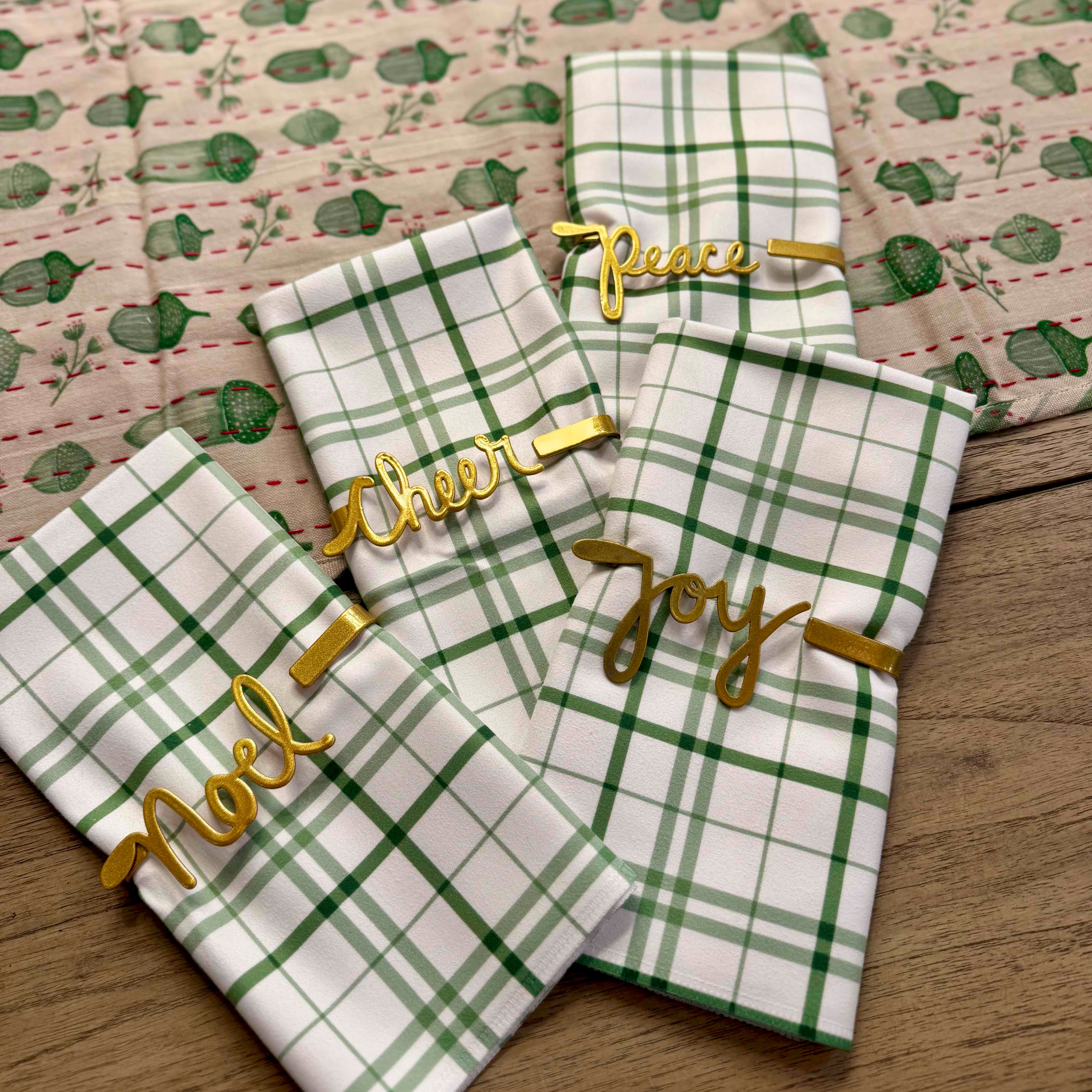 Green and white checkered towels with gold text on a wooden surface