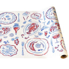 Roll of decorative paper with red and blue food illustrations on a white background