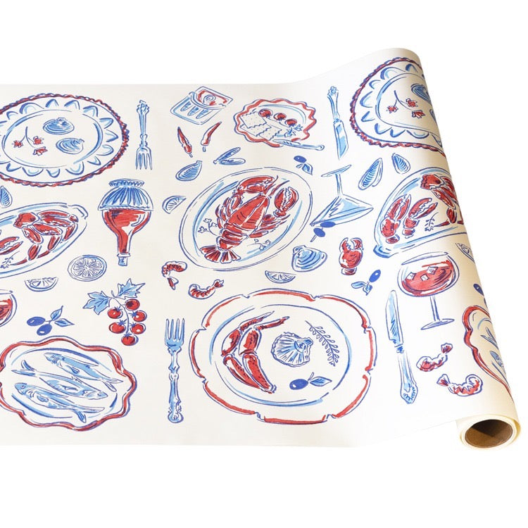 Roll of decorative paper with red and blue food illustrations on a white background