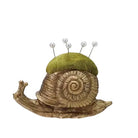 Snail-shaped pincushion with green top and pearl pins on a white background