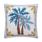 A square throw pillow featuring a hand-tufted design of two palm trees. The design has a white textured background with blue palm fronds, brown trunks, and a blue and gold geometric border.