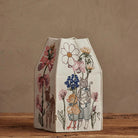 Decorative box with animal and floral illustrations on a wooden surface.