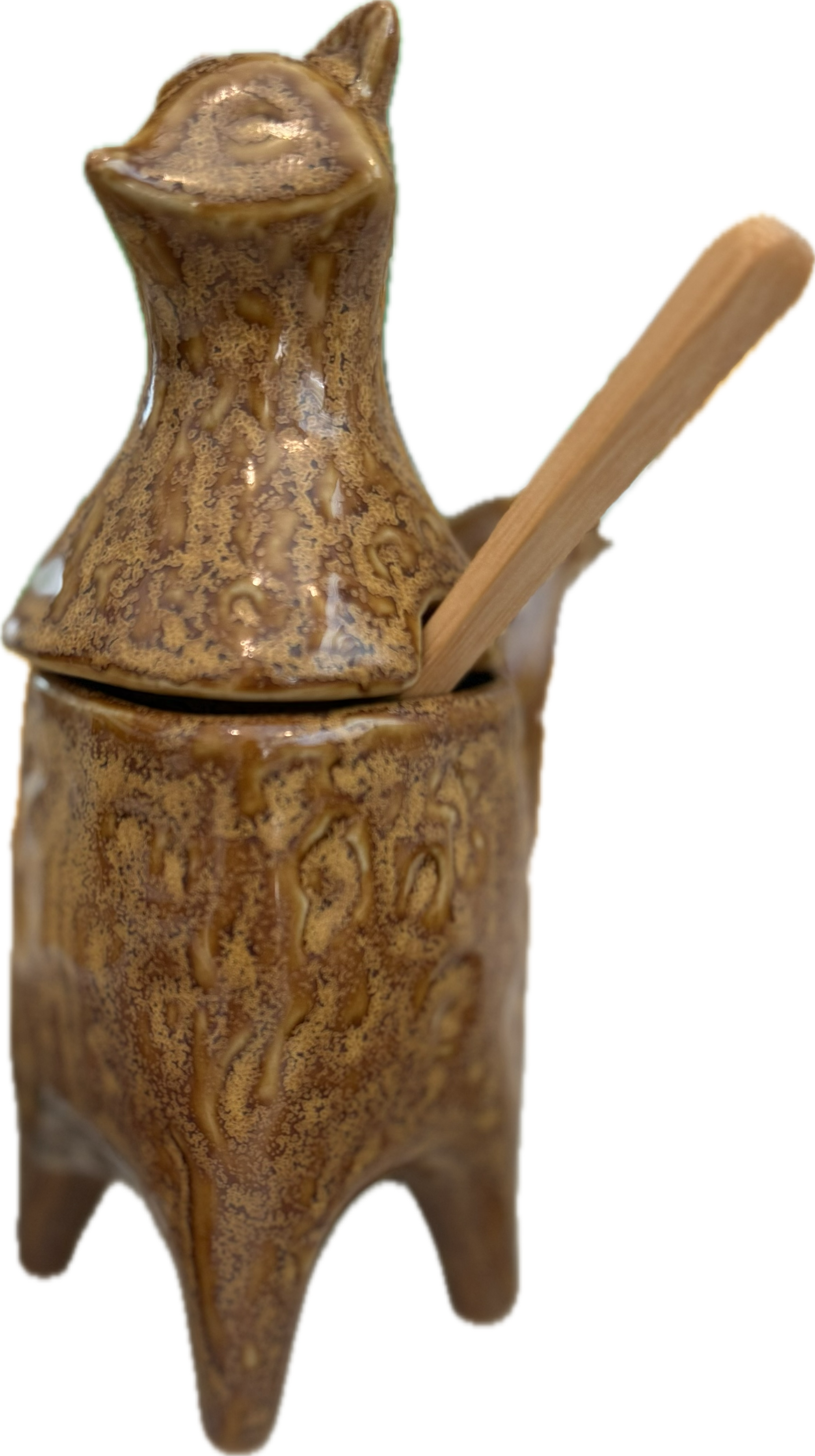 Brown ceramic container with lid and wooden handle on a white background