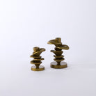 Two small stone figures on a white background