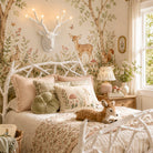 Decorative bedroom with floral wallpaper, deer head mount, and bed with patterned bedding.