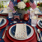 Dining table set for a patriotic theme with red, white, and blue decorations.