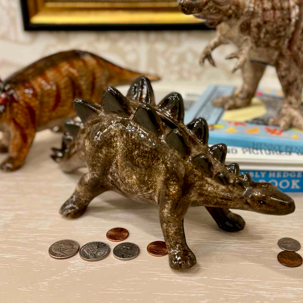 Dinosaur toy with coins on a surface