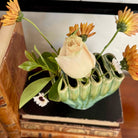 Vase with flowers on a stack of books