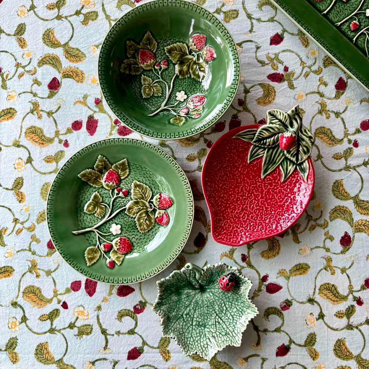 Decorative ceramic plates with floral designs on a patterned surface