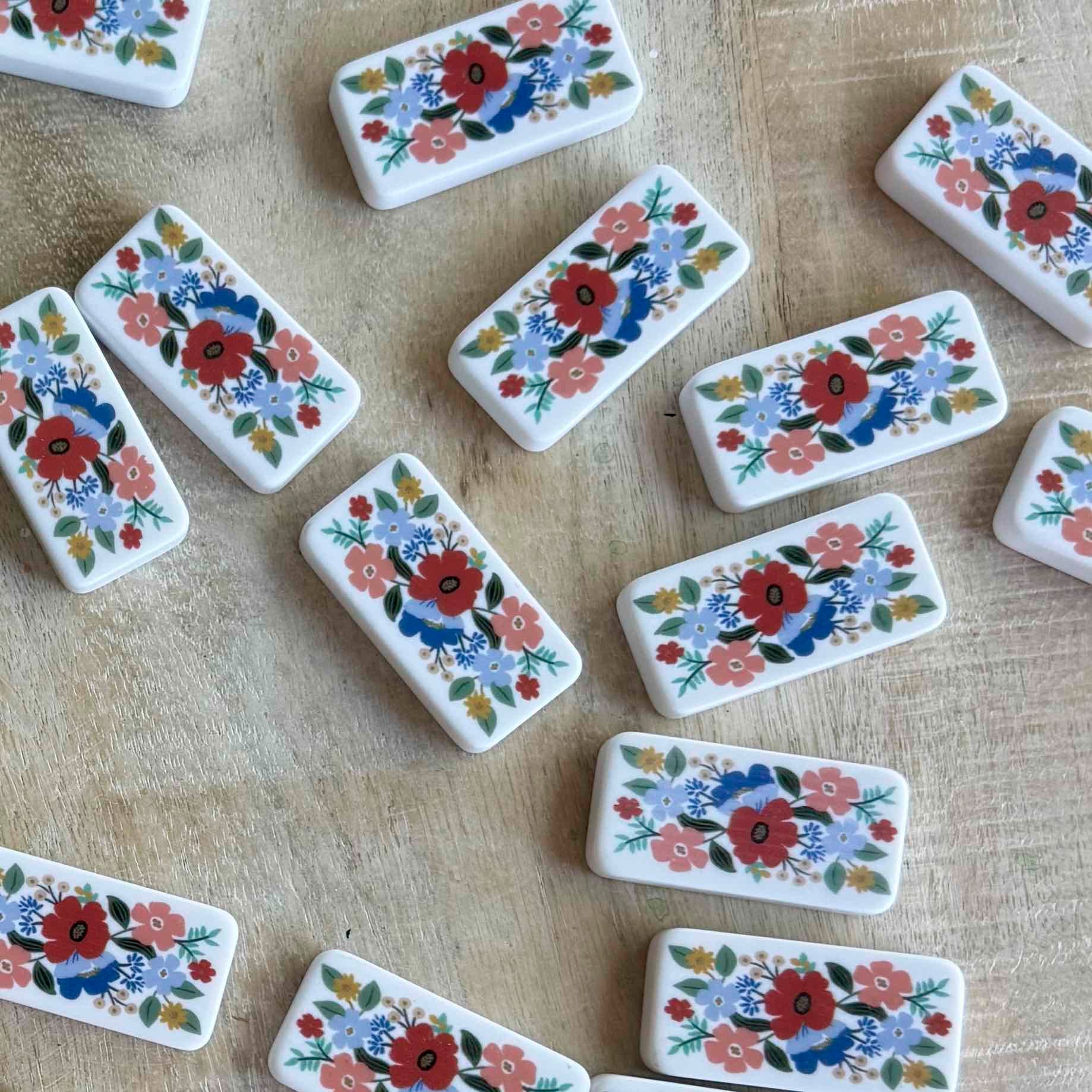 Set of decorative tiles with floral patterns on a textured surface