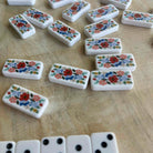 Set of floral dominoes on a wooden surface