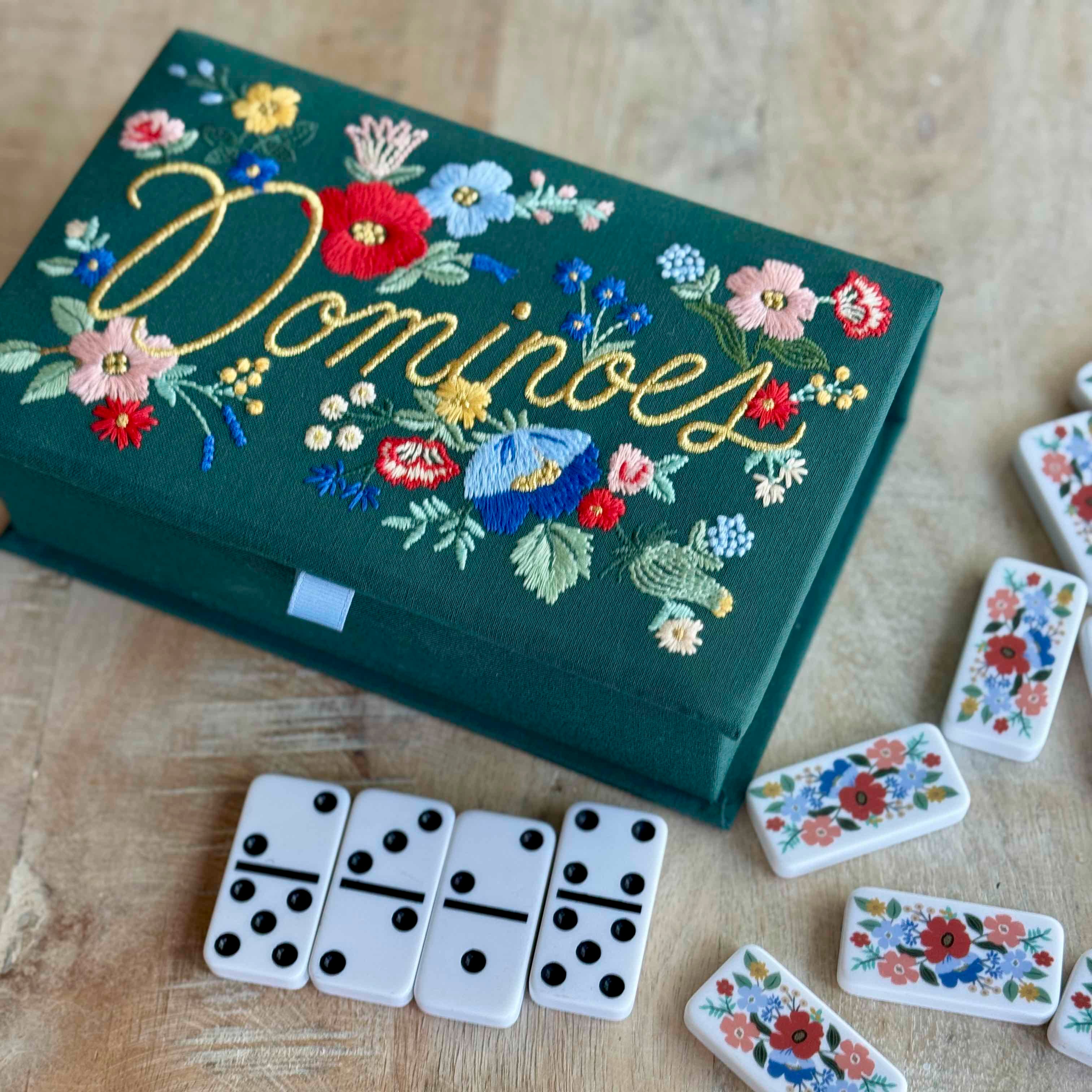 Domino set with floral design on a wooden surface