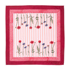 Fabric square with floral pattern and red border on a white background