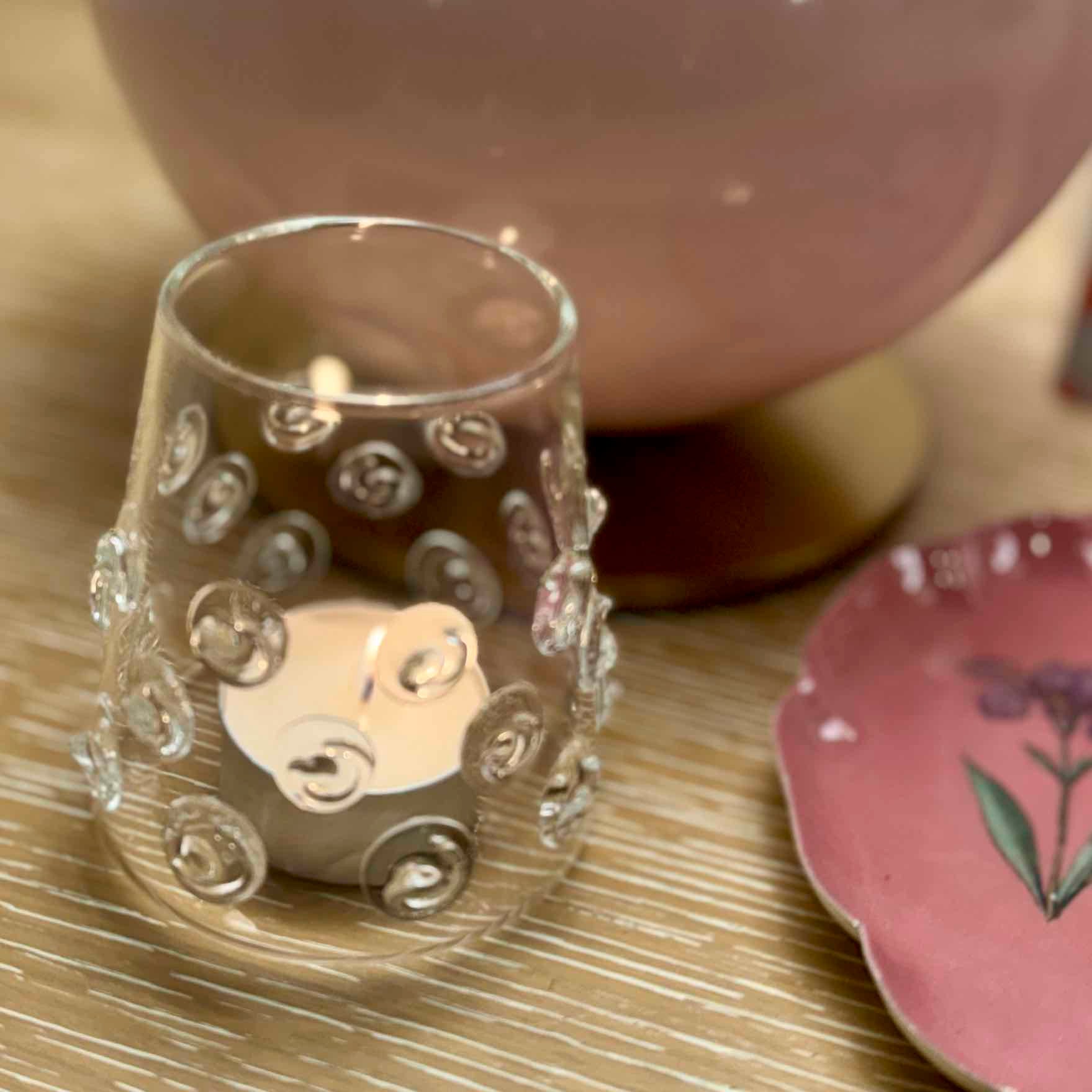 Decorative glass with intricate designs on a wooden surface