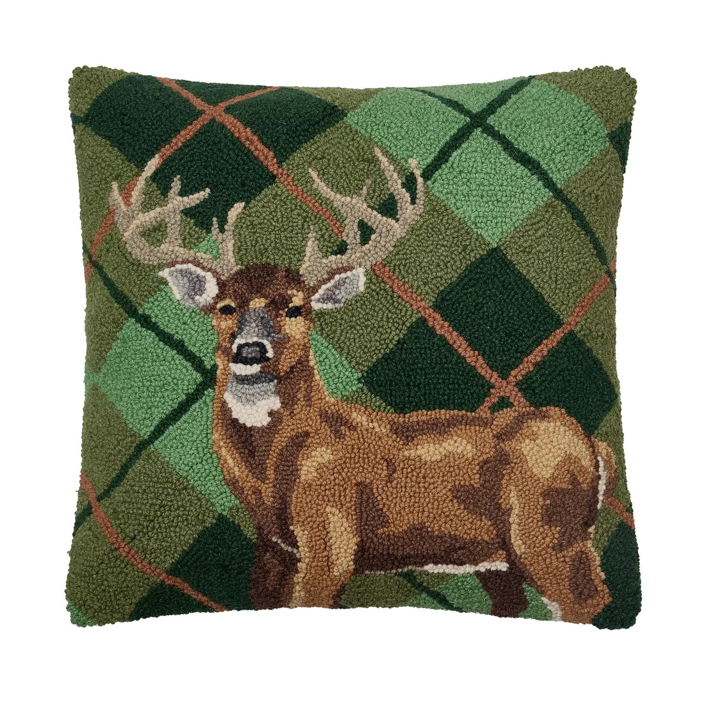 Decorative pillow with a deer design on a green plaid background