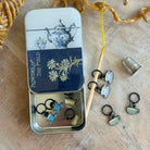 Small metal tin with decorative elements on a wooden surface