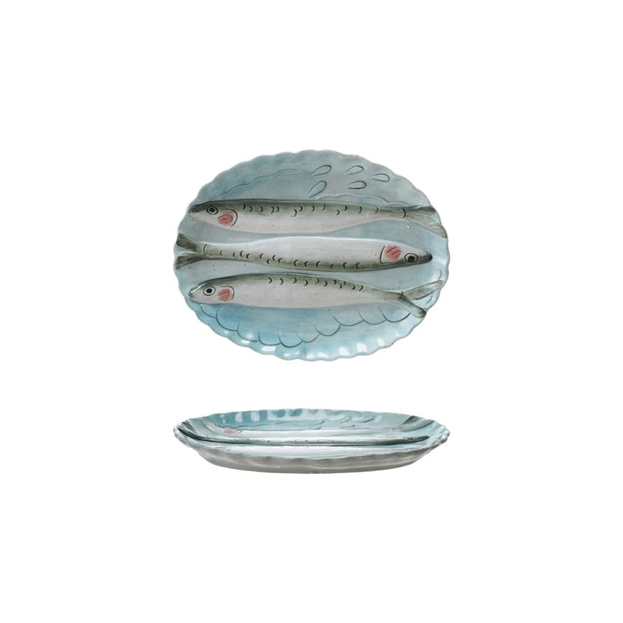 Ceramic plate with fish design on a white background