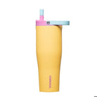 Yellow tumbler with pink and blue lid on a white background