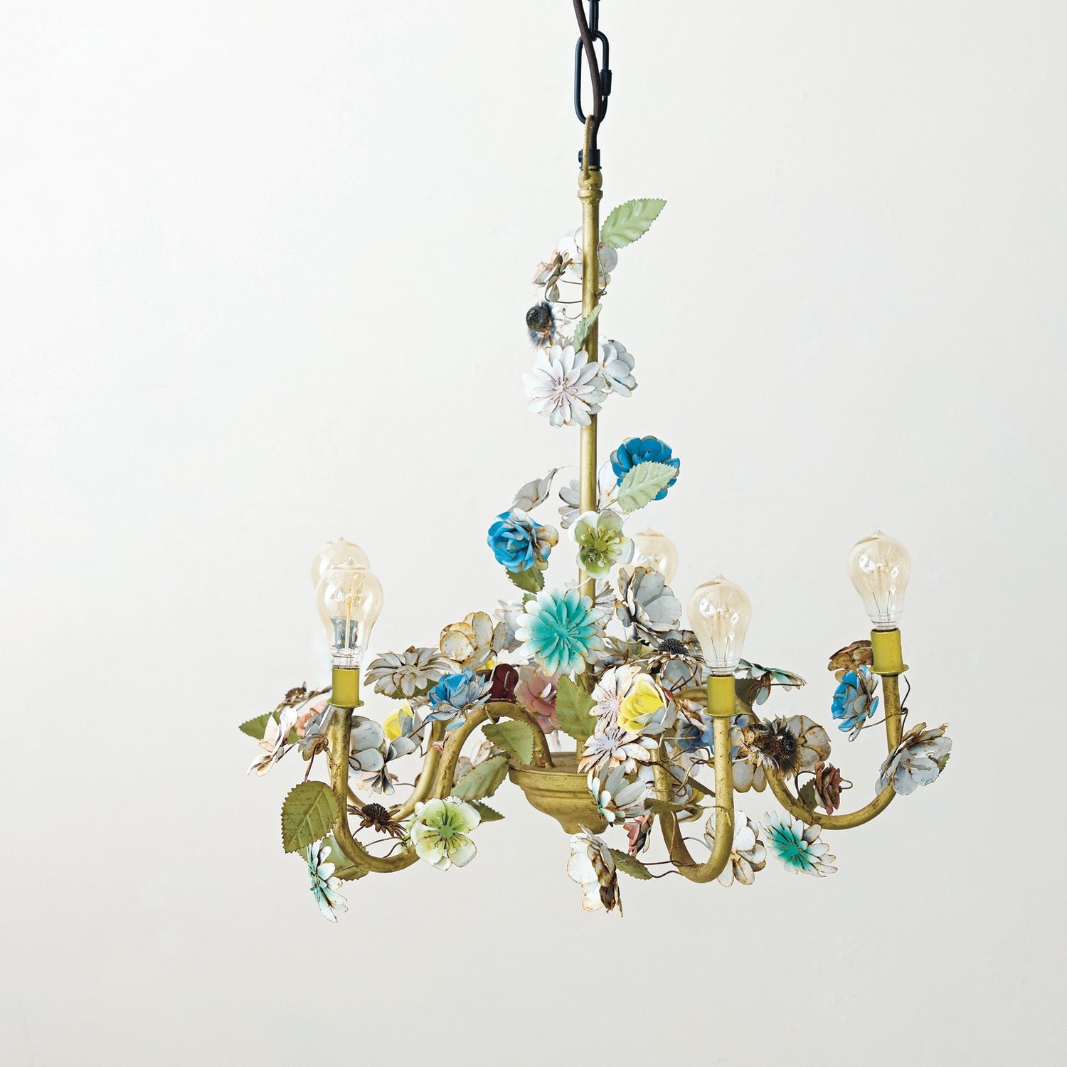 Decorative chandelier with floral and leaf designs on a white background
