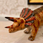 Dinosaur figurine with a textured surface on a neutral background