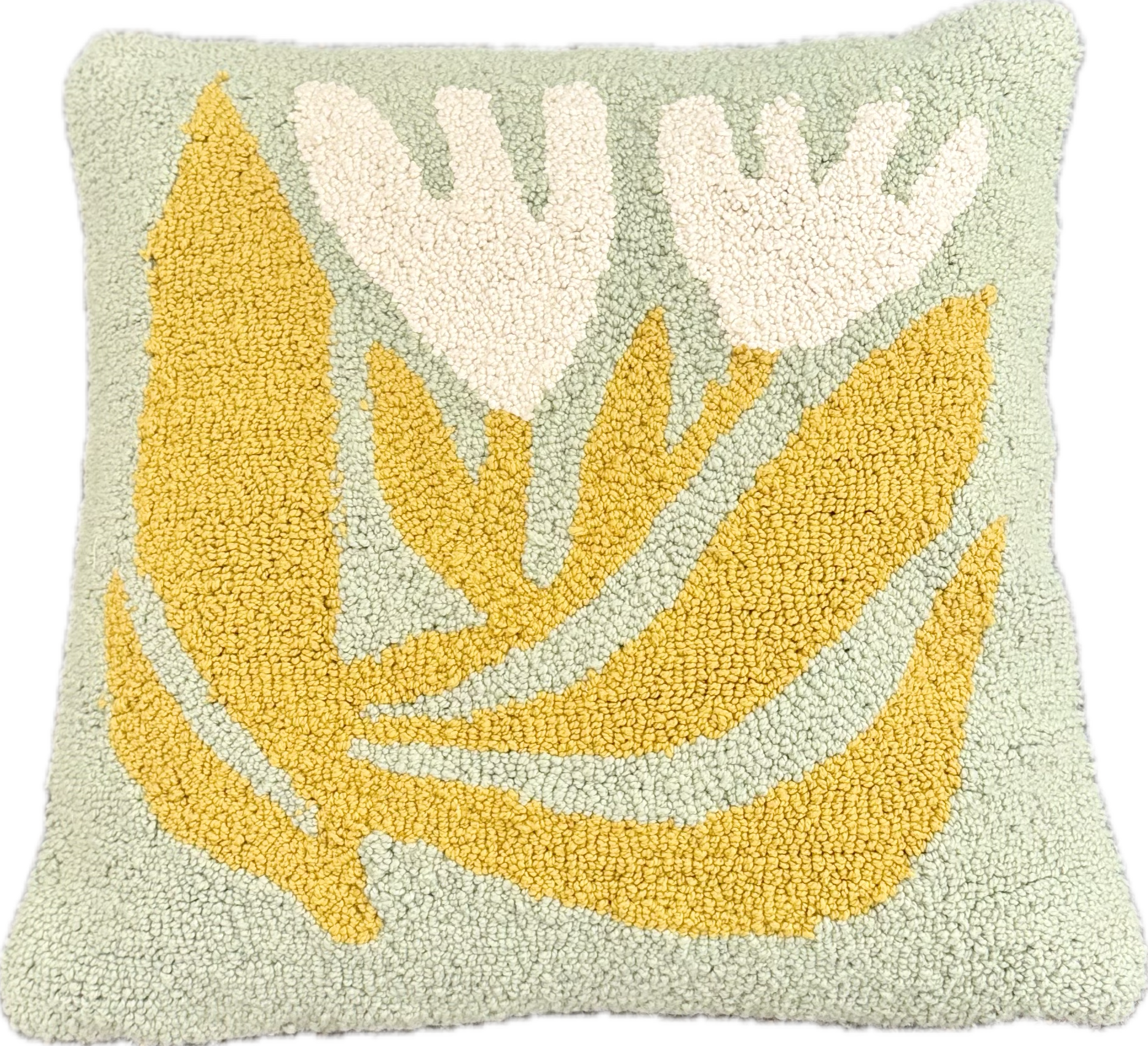 Decorative pillow with yellow and white leaf pattern on a light green background