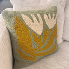 Decorative pillow with leaf pattern on a couch