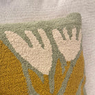 Textured pillow with leaf pattern on a neutral background