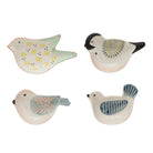 Four ceramic bird-shaped dishes with different designs on a white background