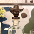 Decorative bottle stopper with a face design on a blurred background